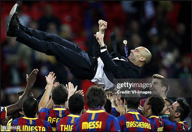 Josep Guardiola manager of Barcelona is thrown in the air as Barcelona celebrate winning the UEFA Champions League final between FC Barcelona and...