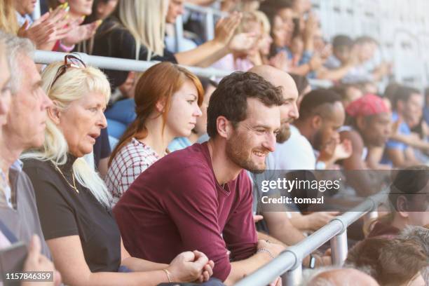 man in crowds on stadium - football crowd stock pictures, royalty-free photos & images