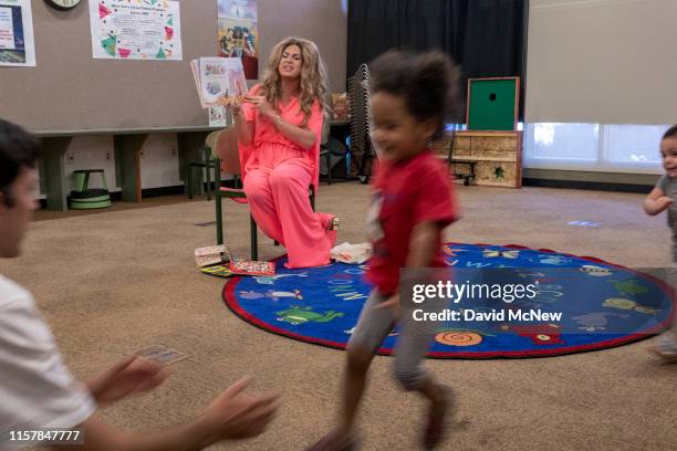 Drag queen "Pickle" reads from a book during the Drag Queen Story Hour program at the West Valley Regional Branch Library on July 26, 2019 in Los...