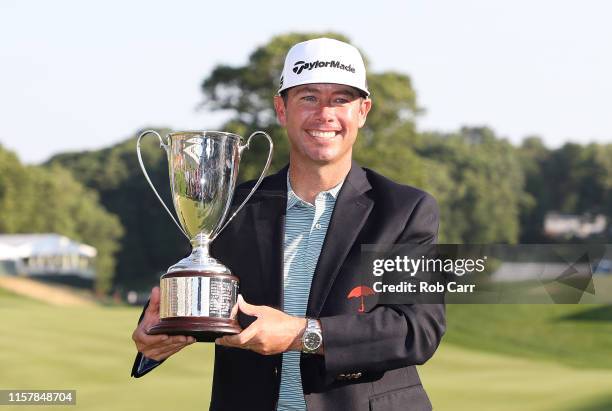 Chez Reavie of the United States poses with the trophy after winning the Travelers Championship at TPC River Highlands on June 23, 2019 in Cromwell,...