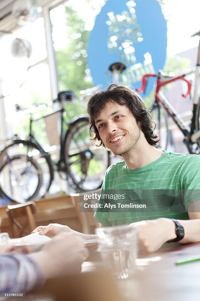 Young man smiling in cafe