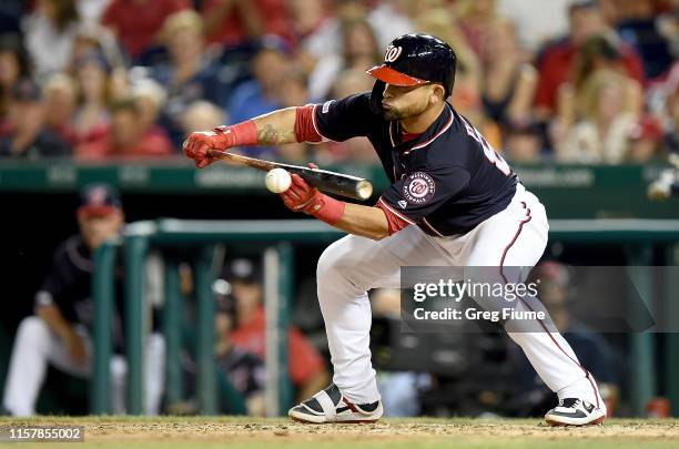 Gerardo Parra of the Washington Nationals bunts in the seventh inning against the Los Angeles Dodgers at Nationals Park on July 26, 2019 in...