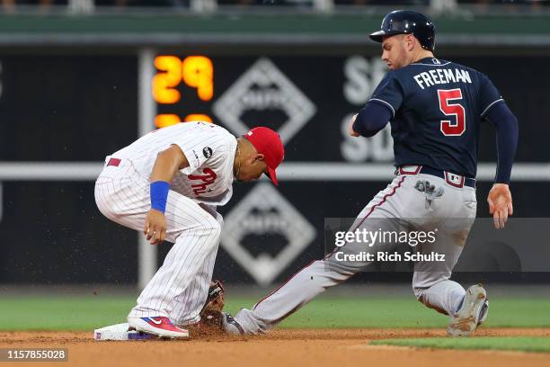 Freddie Freeman of the Atlanta Braves is tagged out while attempting to steal by second baseman Cesar Hernandez of the Philadelphia Phillies during...