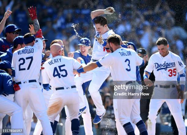 Will Smith of the Los Angeles Dodgers jumps at home plate in celebration of his walk-off two run homerun, for a 5-3 win over the Colorado Rockies,...