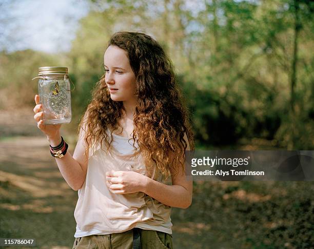 girl with butterly in a jar in forest - 13 stock pictures, royalty-free photos & images