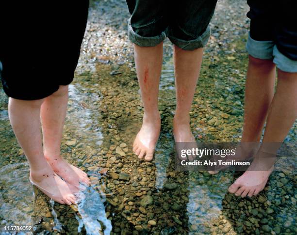 three children standing in stream - teen boy barefoot stock pictures, royalty-free photos & images