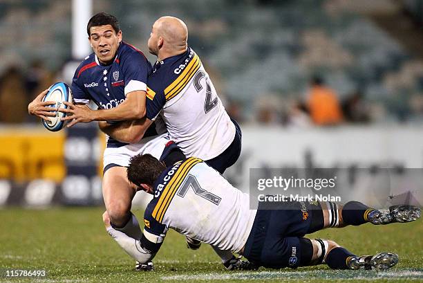 Mark Gerrard of the Storm is tackled during the round 17 Super Rugby match between the Brumbies and the Rebels at Canberra Stadium on June 10, 2011...