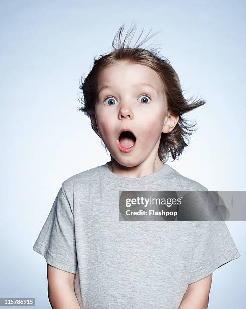 portrait of boy looking surprised - surprise portrait photos et images de collection