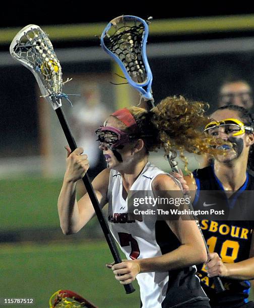 Madison's Katie Kerrigan sets up to shoot in the second half of her teams game against Osbourn Park on June 7, 2011. Her shot would score. Behind...