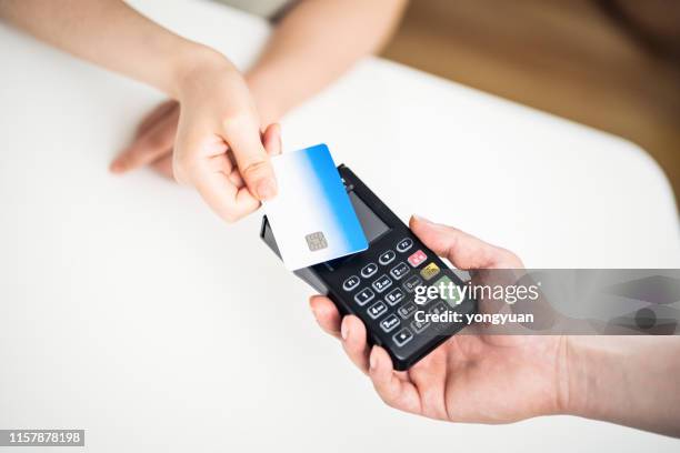 tapping credit card for contactless payment - tapping stock pictures, royalty-free photos & images