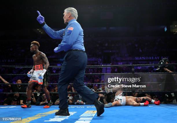 Referee Jay Nady sends Jermell Charlo to a neutral corner after Charlo knocks down Jorge Cota during the third round of their super welterweight...