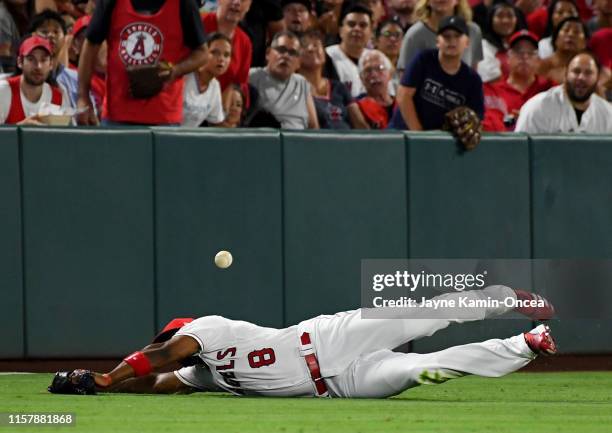 Anthony Santander of the Baltimore Orioles hits a double past a diving Justin Upton of the Los Angeles Angels in the fourth inning of the game at...