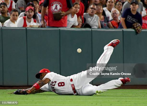 Anthony Santander of the Baltimore Orioles hits a double past a diving Justin Upton of the Los Angeles Angels in the fourth inning of the game at...