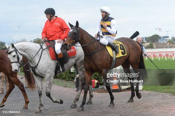 Damien Oliver returns to the mounting yard on Benitoite after winning the Jenna Ross VOBIS Gold Reef at Caulfield Racecourse on July 27, 2019 in...