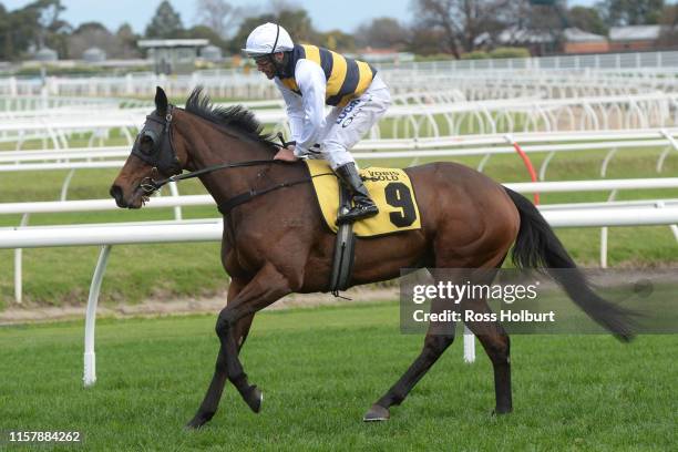 Damien Oliver returns to the mounting yard on Benitoite after winning the Jenna Ross VOBIS Gold Reef at Caulfield Racecourse on July 27, 2019 in...