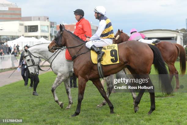 Damien Oliver returns to the mounting yard on Benitoite after winning the Jenna Ross VOBIS Gold Reef at Caulfield Racecourse on July 27, 2019 in...