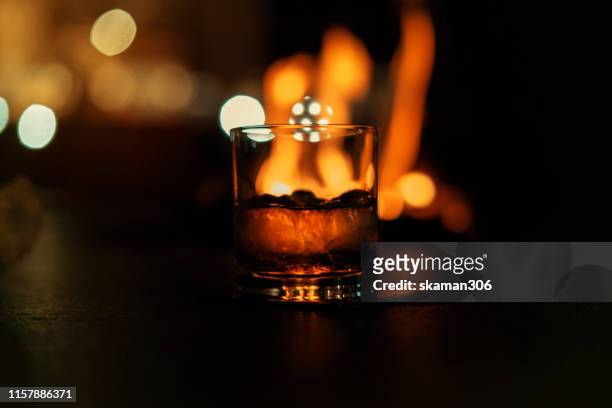 selective focus pure whisky with ice cube inside whisky glass on copyspace background - tequila tasting stock pictures, royalty-free photos & images