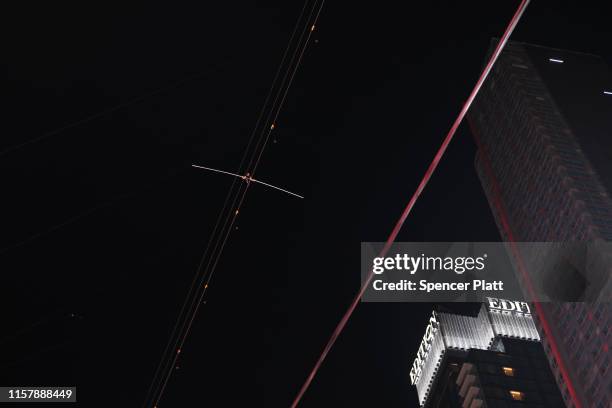 Nik Wallenda walks towards his sister Lijana Wallenda across Times Square on a high wire strung between two skyscrapers 25 stories above the pavement...