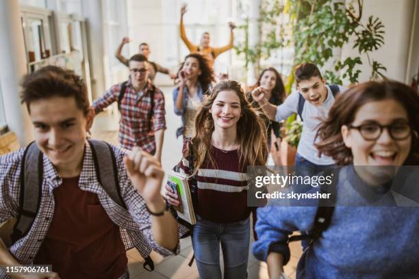 stor grupp av glada studenter som springer genom skolans korridor. - happy ending bildbanksfoton och bilder