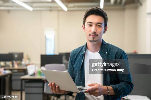 portrait of young professional in modern office - korea technology stock pictures, royalty-free photos & images