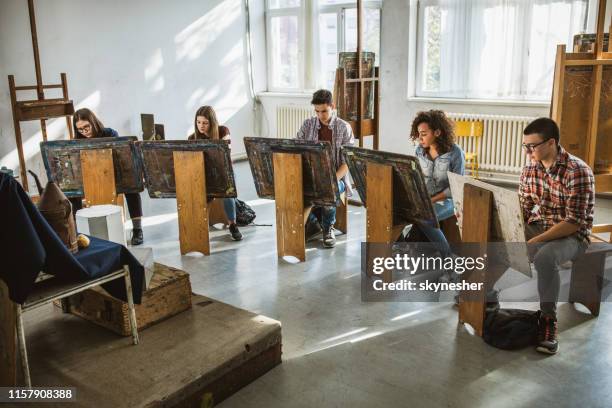 group of students drawing their paintings on a class at art studio. - art class stock pictures, royalty-free photos & images