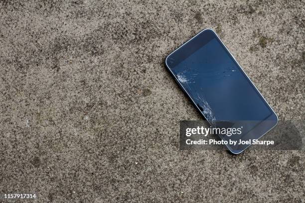 smashed phone on concrete - broken concrete stock pictures, royalty-free photos & images