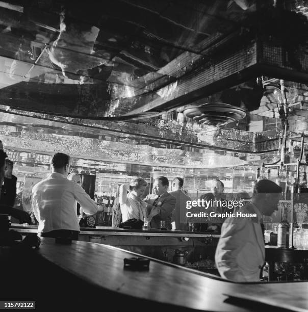 Customers and staff at the bar of the Latin Quarter nightclub, Times Square, New York City, 1951.