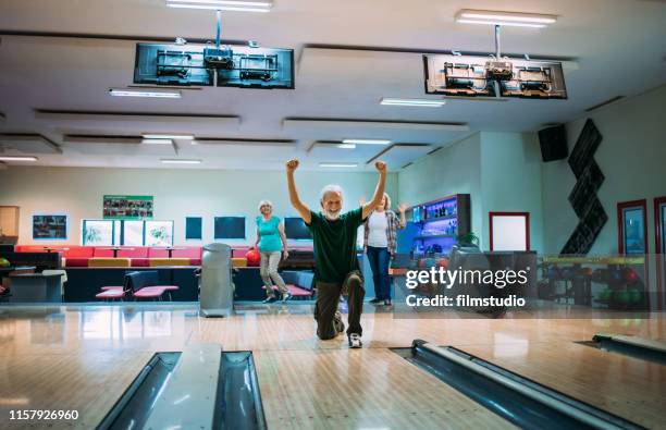 senior friends bowling - bowling stock pictures, royalty-free photos & images