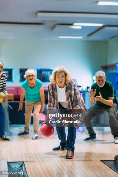 senior friends bowling - senior men bowling stock pictures, royalty-free photos & images