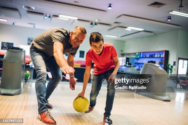 man bowling with his son - kids bowling stock pictures, royalty-free photos & images