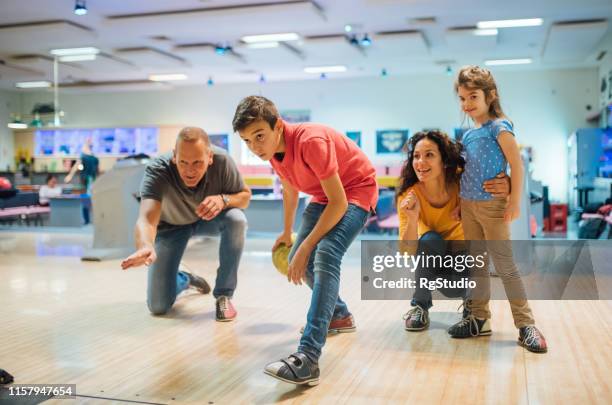 familie auf der kegelbahn - family bowling stock-fotos und bilder