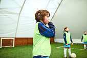 Cute Boy With Cochlea Implant At Kids Soccer Training