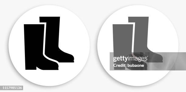 big boots black and white round icon - rain boots stock illustrations