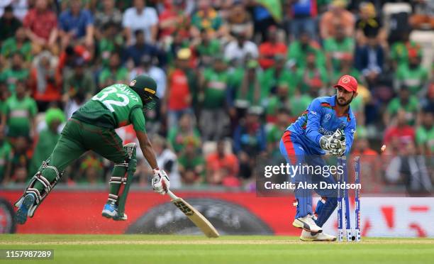 Ikram Ali Khil of Afghanistan attempts to run out Mohammad Saifuddin of Bangladesh during the Group Stage match of the ICC Cricket World Cup 2019...