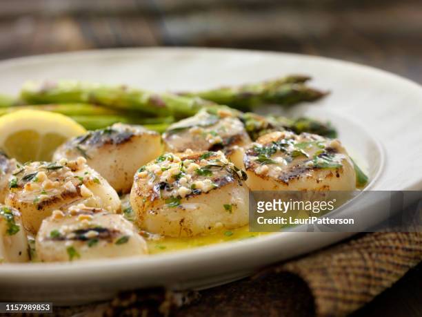 bbq grilled scallops with grilled asparagus and a herb, garlic butter sauce - seared stock pictures, royalty-free photos & images