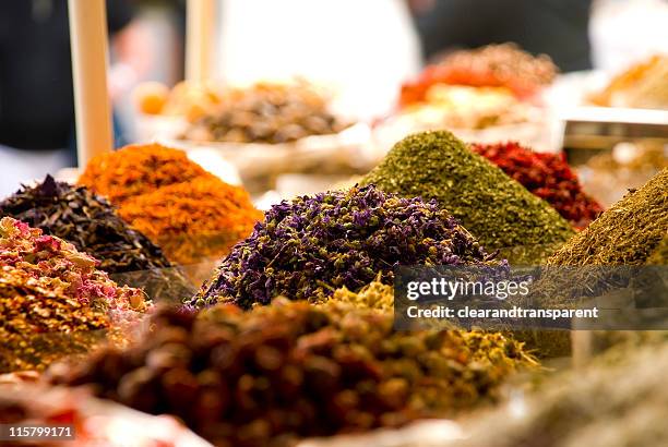 bags of colorful spices for sale at the souq - wierook stockfoto's en -beelden