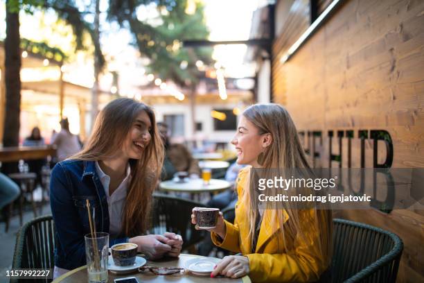 gossip time for female friends in cafe - springtime friends stock pictures, royalty-free photos & images