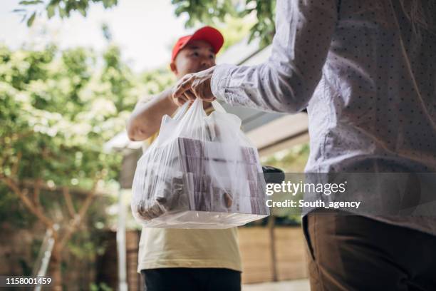 delivery man bringing food - order takeout stock pictures, royalty-free photos & images