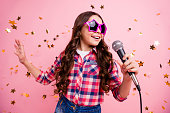 Close up photo of cool attractive crazy lady kid have fun visit event future musician loud voice solo hold hand free time stylish checked shirt isolated over pink background long haircut hairdo