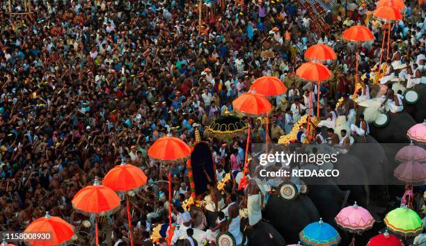 Thrissur Pooram festival. The competition called 'Kudamattam'. The swift and rhythmic changing of brightly colored parasols along with the raising...