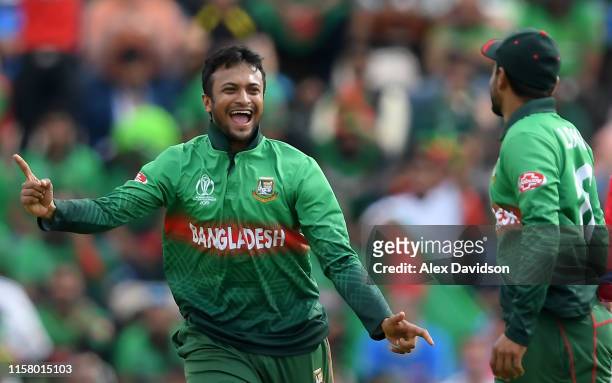 Shakib Al Hasan of Bangladesh celebrates the wicket of Gulbadin Naib of Afghanistan with Liton Das of Bangladesh during the Group Stage match of the...