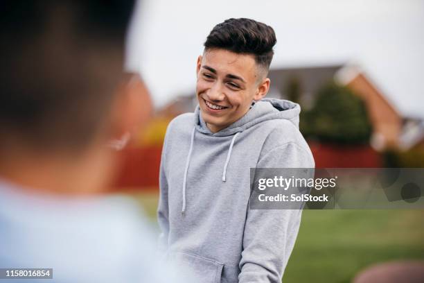 teenage boy socialising with friends - 14 years old boy stock pictures, royalty-free photos & images