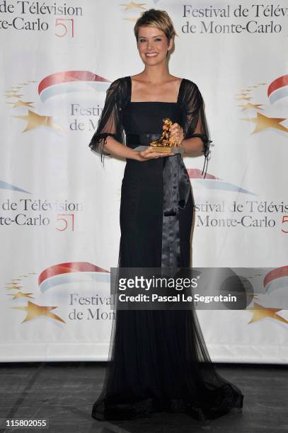 Andrea Osvart poses with her Golden Nymphe award after the closing ceremony of the 2011 Monte Carlo Television Festival held at the Grimaldi Forum on...