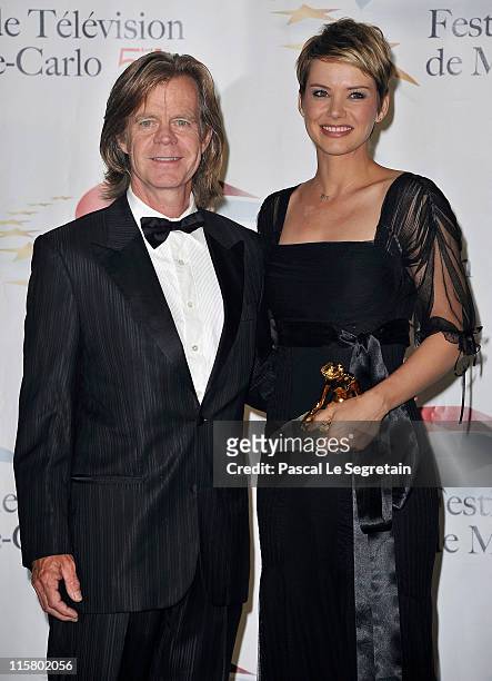Andrea Osvart poses with her Golden Nymphe award next to William H. Macy after the closing ceremony of the 2011 Monte Carlo Television Festival held...