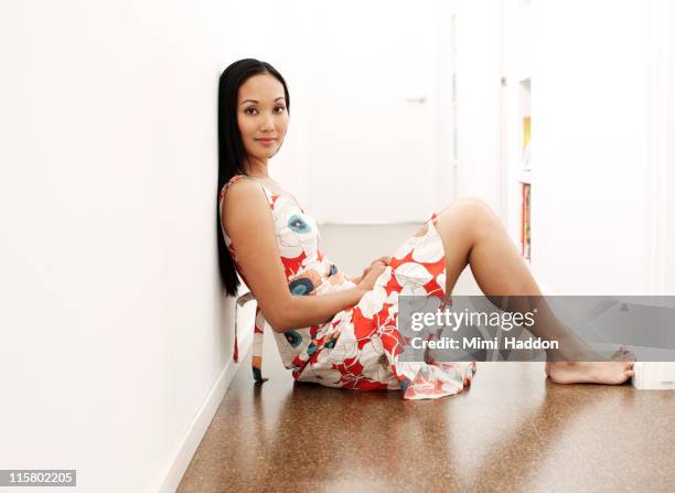 asian woman sitting on hallway floor - barefoot landing stock pictures, royalty-free photos & images
