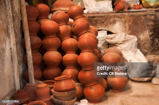 earthen pot being made using potter's wheel, india - tongeschirr stock-fotos und bilder