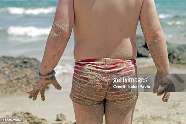 boy's butt dirty with sand at the beach - beach bum imagens e fotografias de stock