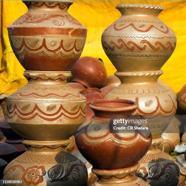 earthen pot for selling made using potter's wheel, india - earthenware stock pictures, royalty-free photos & images