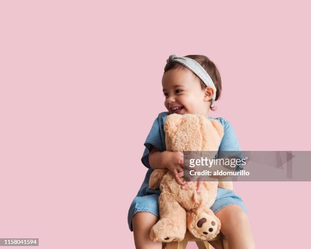 cheerful toddler with her favorite toy - stuffed toy stock pictures, royalty-free photos & images