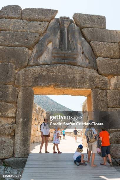 tourists at lion gate mycenae, archaeological place in greece - arcadia greece stock pictures, royalty-free photos & images